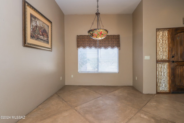 unfurnished dining area with concrete floors