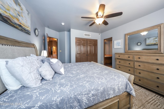 bedroom with ensuite bath, a closet, and ceiling fan