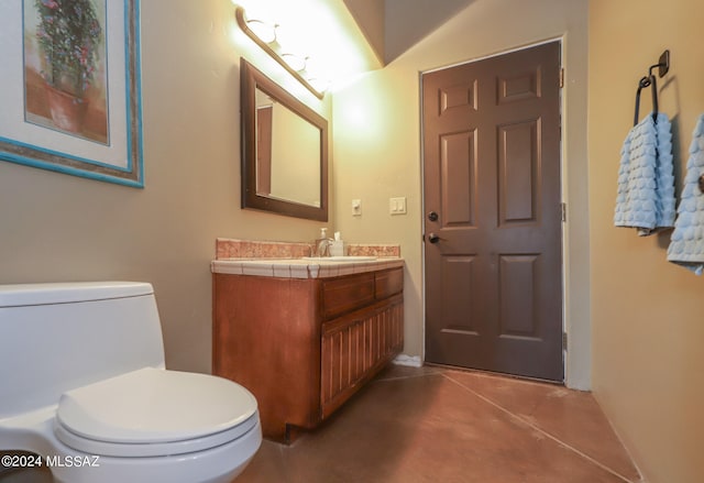 bathroom featuring concrete flooring, toilet, and vanity