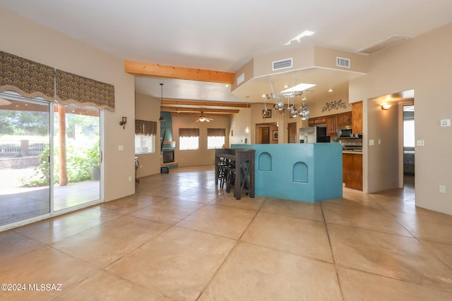 kitchen featuring appliances with stainless steel finishes, ceiling fan, and beam ceiling