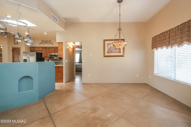 kitchen featuring decorative light fixtures, appliances with stainless steel finishes, and decorative backsplash