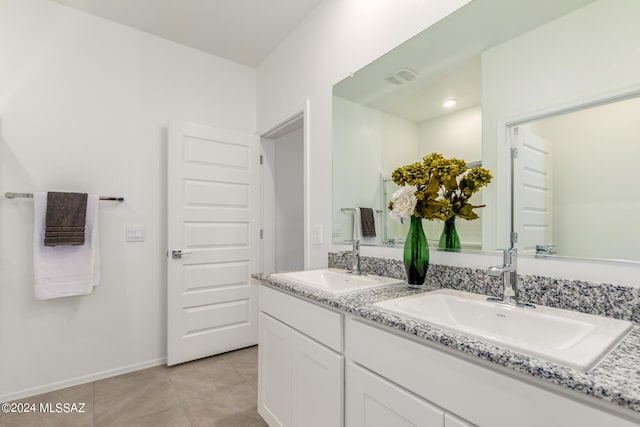 bathroom featuring tile patterned flooring and vanity