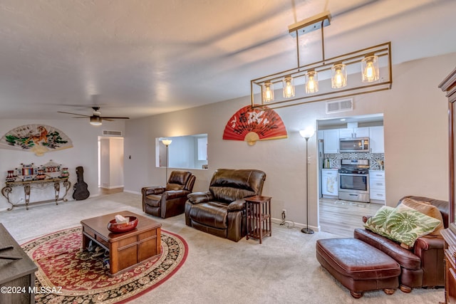 living area with ceiling fan, baseboards, visible vents, and light carpet