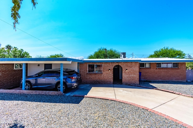 ranch-style house featuring a carport and central air condition unit