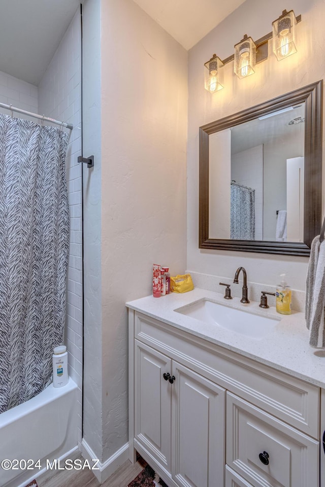 bathroom featuring shower / tub combo and vanity