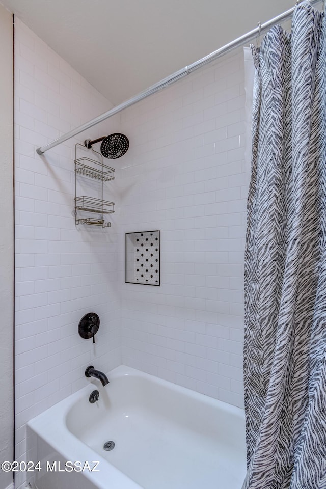 bathroom with shower / bath combo with shower curtain