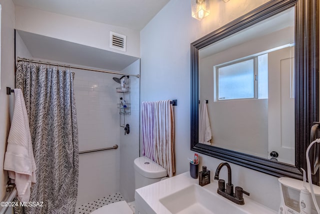 bathroom featuring curtained shower, vanity, and toilet