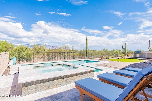 view of pool with a patio and an in ground hot tub