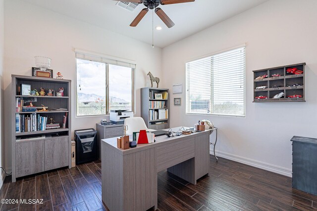 office space featuring a healthy amount of sunlight, ceiling fan, and dark hardwood / wood-style floors