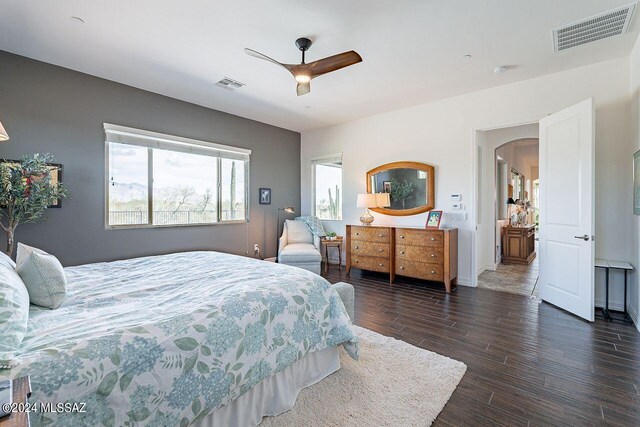 bedroom with ceiling fan and dark hardwood / wood-style floors