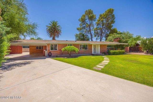 ranch-style house with a front lawn and a carport