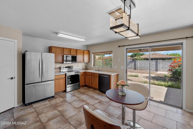 kitchen with stainless steel appliances and light tile patterned flooring