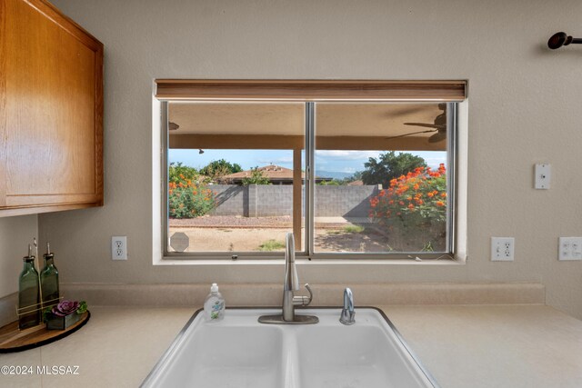 interior space with ceiling fan and sink