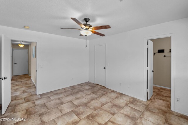 spare room featuring light tile patterned flooring and ceiling fan