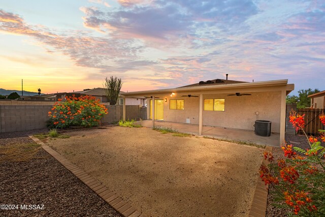 back house at dusk with a patio