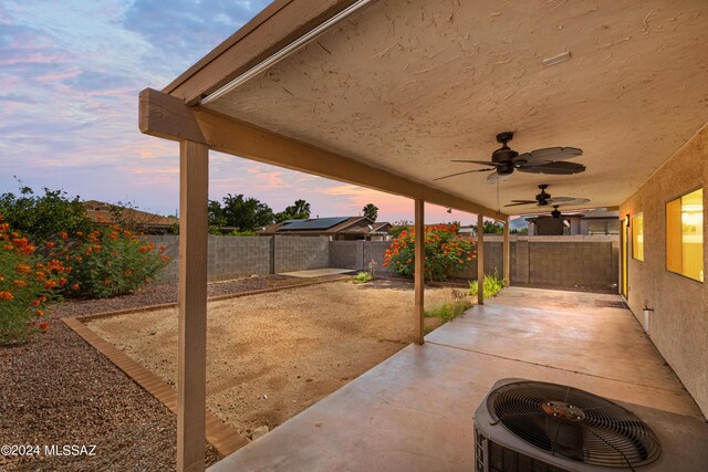 patio terrace at dusk with ceiling fan and central air condition unit