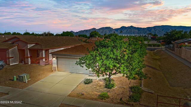 single story home featuring a mountain view and a garage