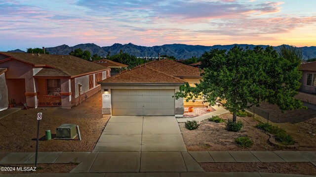 view of front of property featuring a garage and a mountain view