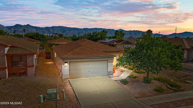 view of front of property featuring a mountain view and a garage