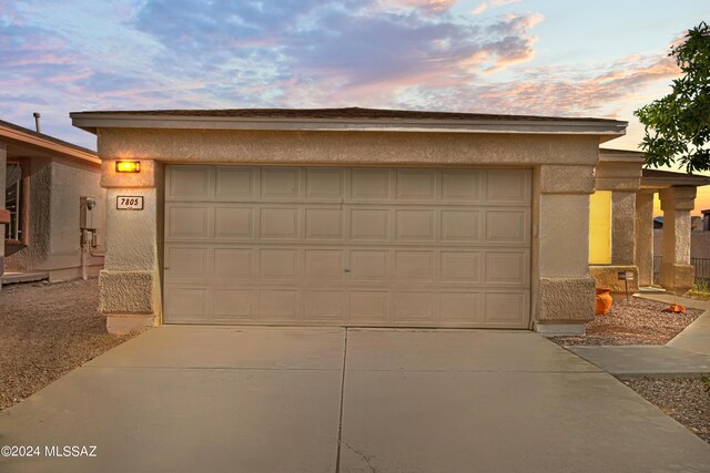 view of garage at dusk