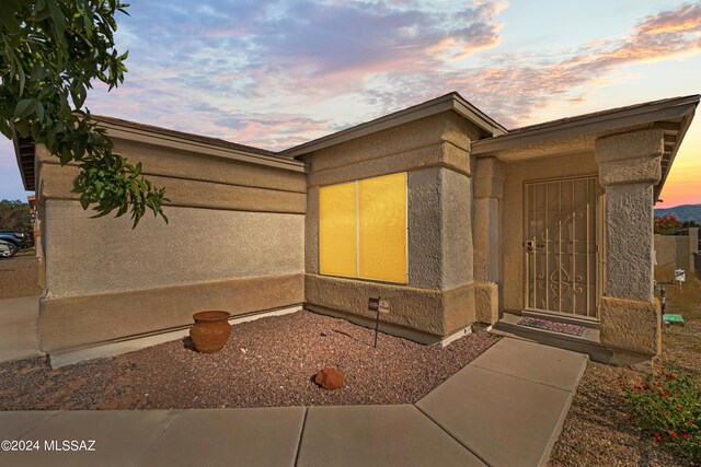 view of exterior entry at dusk