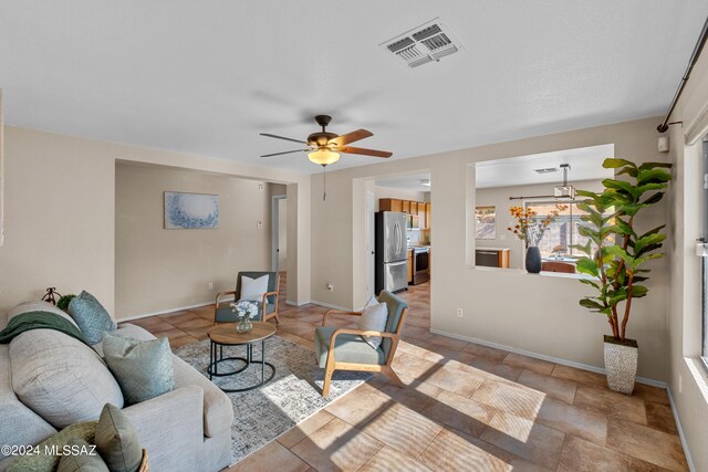 tiled living room with ceiling fan