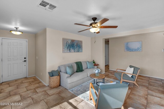 living room featuring ceiling fan and light tile patterned floors