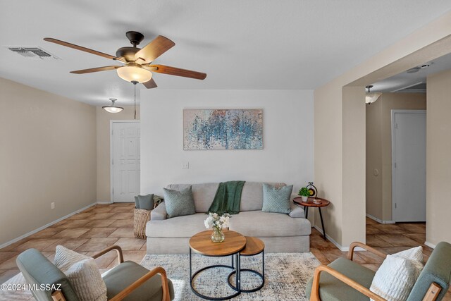 tiled living room featuring ceiling fan