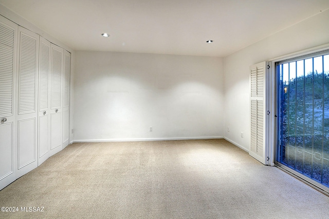 unfurnished bedroom featuring light carpet