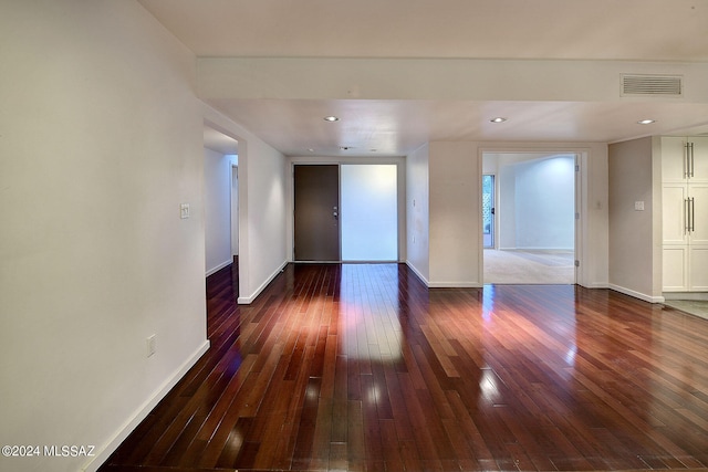 empty room with dark hardwood / wood-style flooring