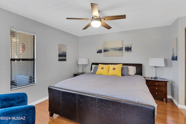 bedroom with ceiling fan and light hardwood / wood-style floors