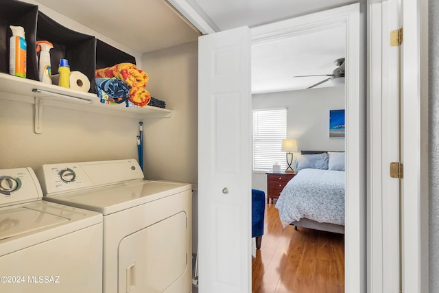 clothes washing area with washing machine and dryer, ceiling fan, and light hardwood / wood-style floors