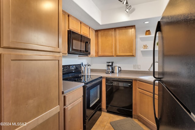 kitchen featuring black appliances, rail lighting, sink, and light tile patterned flooring