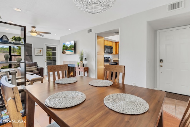 tiled dining area featuring ceiling fan