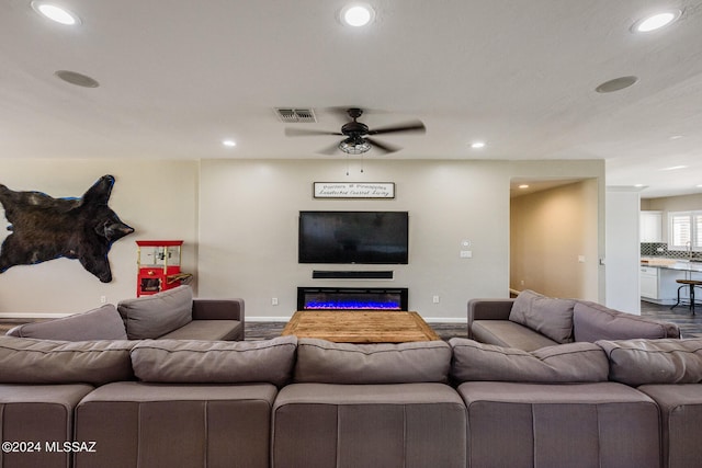 living room featuring ceiling fan and hardwood / wood-style flooring