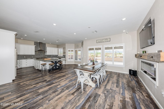 dining area featuring dark wood-type flooring