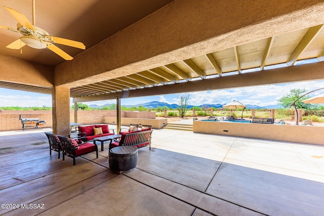 view of patio / terrace with a mountain view, outdoor lounge area, and ceiling fan