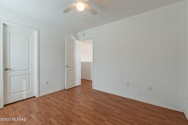 unfurnished bedroom with light wood-style floors, baseboards, and a ceiling fan