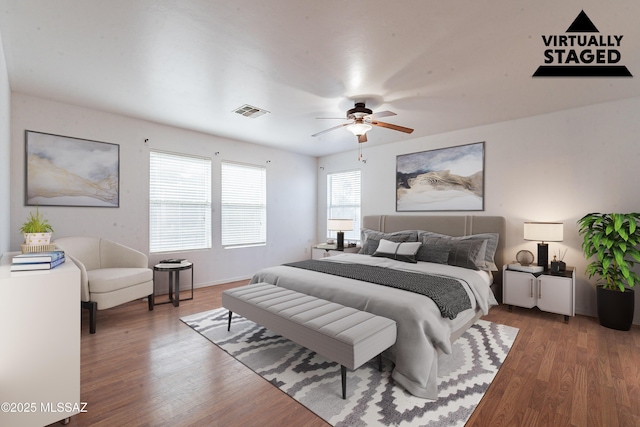 bedroom featuring ceiling fan, visible vents, and wood finished floors