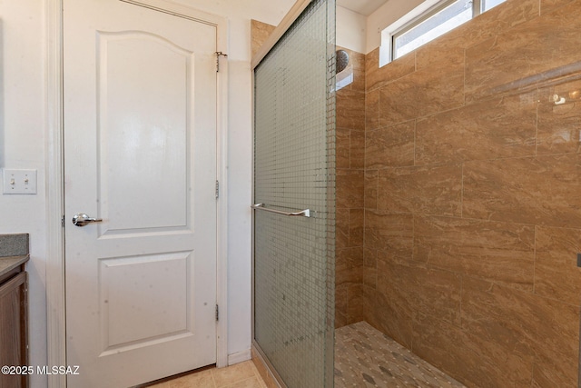 bathroom with a stall shower and tile patterned flooring