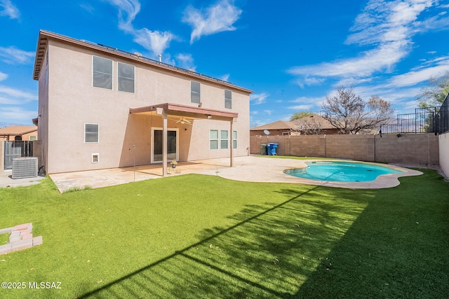 back of house with a patio area, stucco siding, and a yard