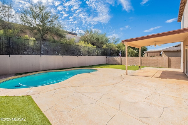 view of pool featuring a patio, a fenced backyard, and a ceiling fan