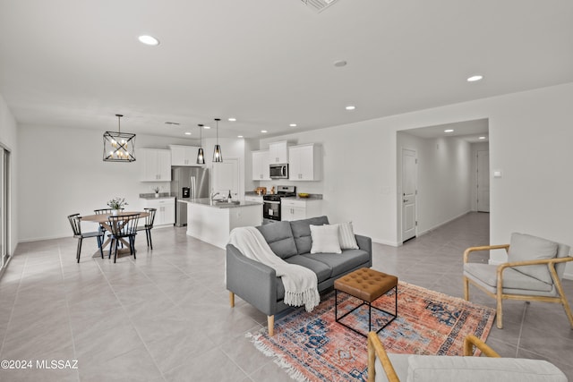 living room with sink and light tile patterned flooring