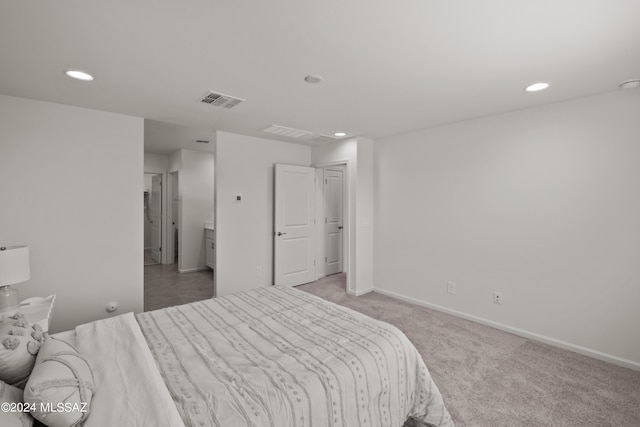 bedroom featuring light carpet