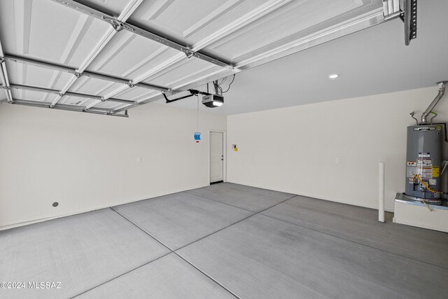 garage featuring gas water heater and a garage door opener