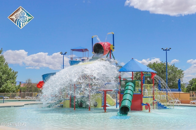 view of jungle gym with a community pool and pool water feature