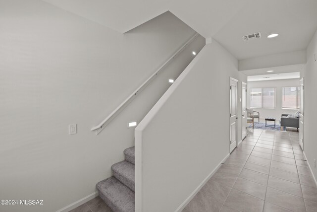 stairs with tile patterned flooring