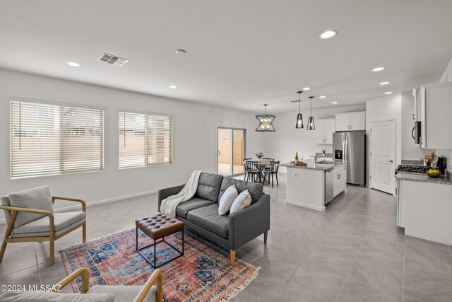 tiled living room featuring sink