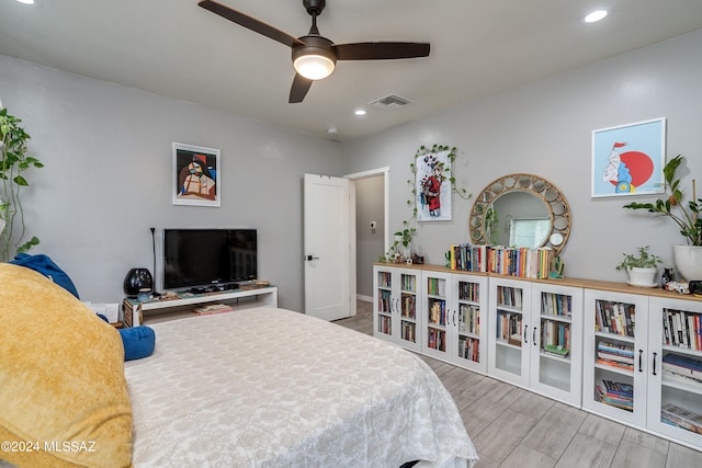 bedroom with ceiling fan and light hardwood / wood-style flooring