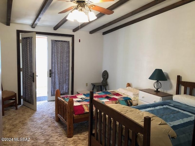 carpeted bedroom with ceiling fan and beamed ceiling